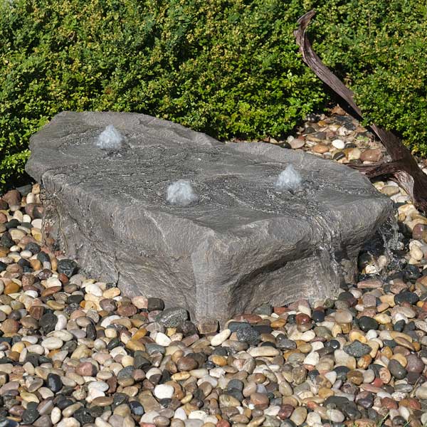 Manistique Falls Fountain Kit on mixed pebbles in the backyard