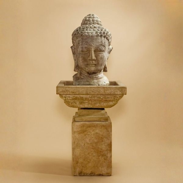 Meditation Buddha Fountain, Tall against brown background.