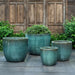 Mendocino Planter - Antique Jade - S/4 on concrete filled with plants.