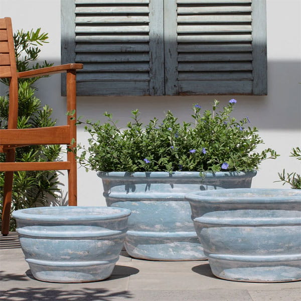 Mera Planter in Murano Celeste on concrete in the backyard.