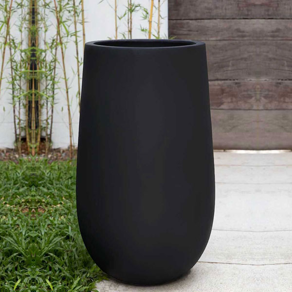 Mews Planter, Large - Onyx Black Lite on concrete filled with plants