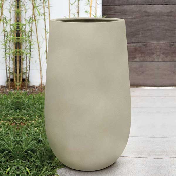 Campania International Mews Planter, Medium - Ivory Lite on concrete filled with plants