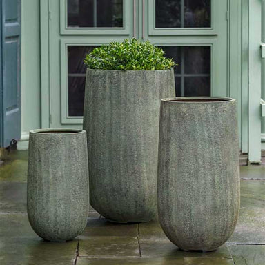 Mews Planter, Small - Verdigris Lite on concrete filled with plants