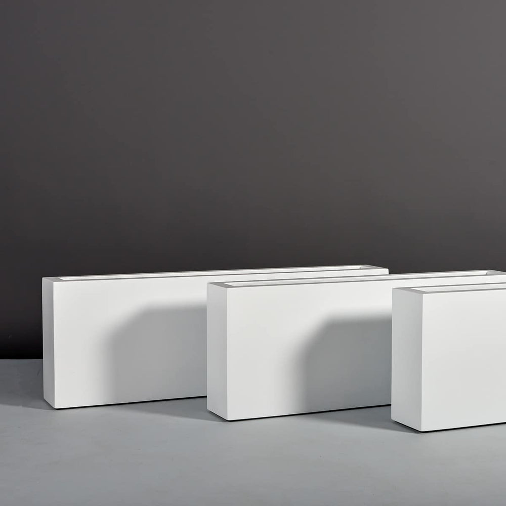 Miami Rectangle Fiberglass Planter on concrete shown with different sizes.