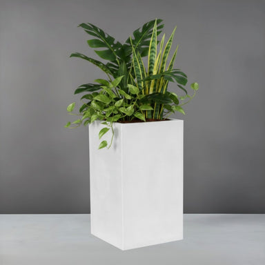 Miami Short Corner Fiberglass Planter filled with plants against gray background.