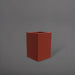 Miami Short Corner Fiberglass Planter in matte terra cotta against gray background.