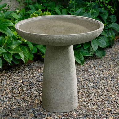 Midford Birdbath on gravel in the backyard.