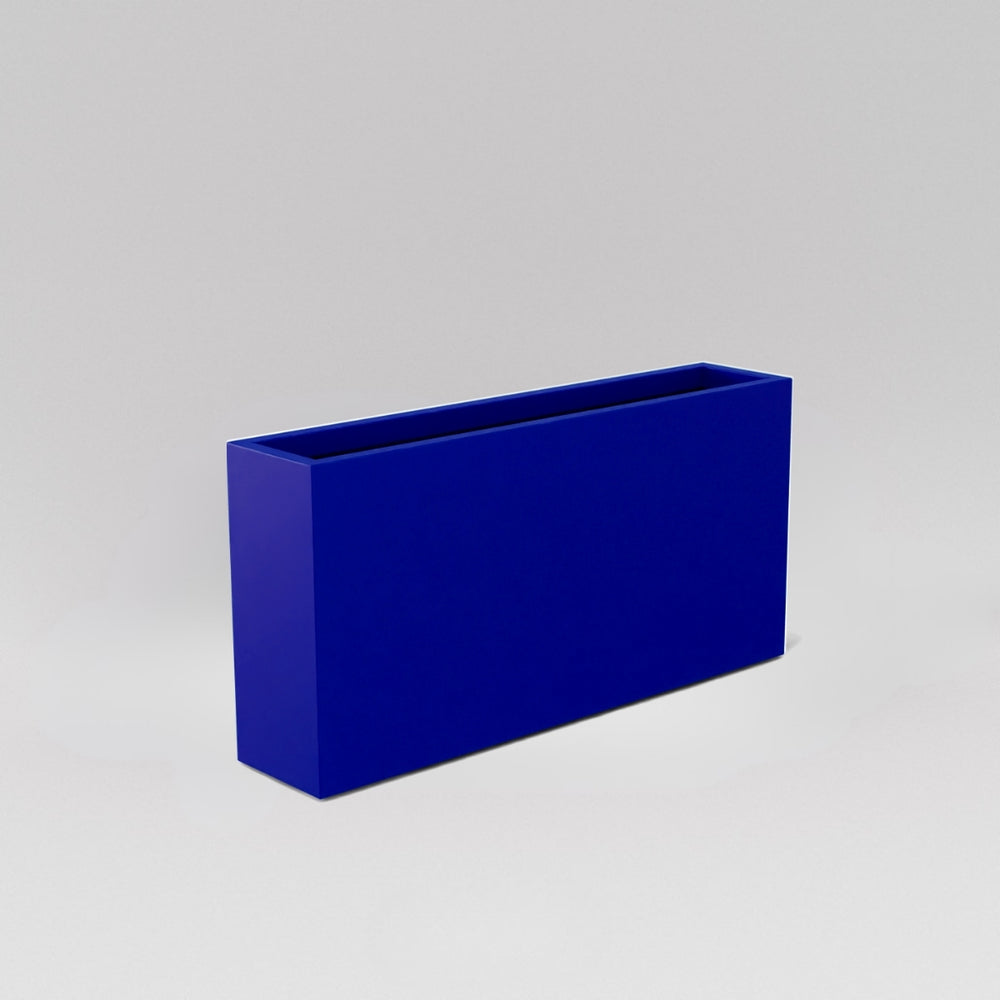 Milano Narrow Rectangle Planter in matte cobalt blue against gray background.