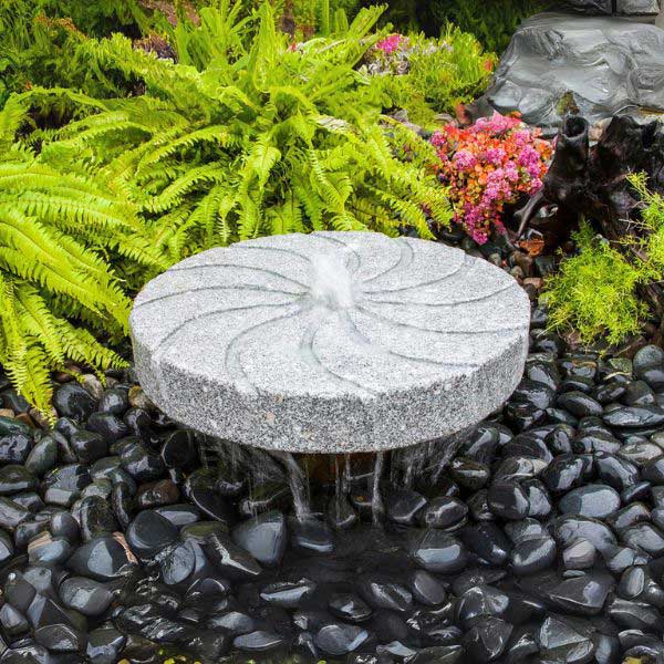 Millstone Fountain Kit Swirl Style on black pebbles in action