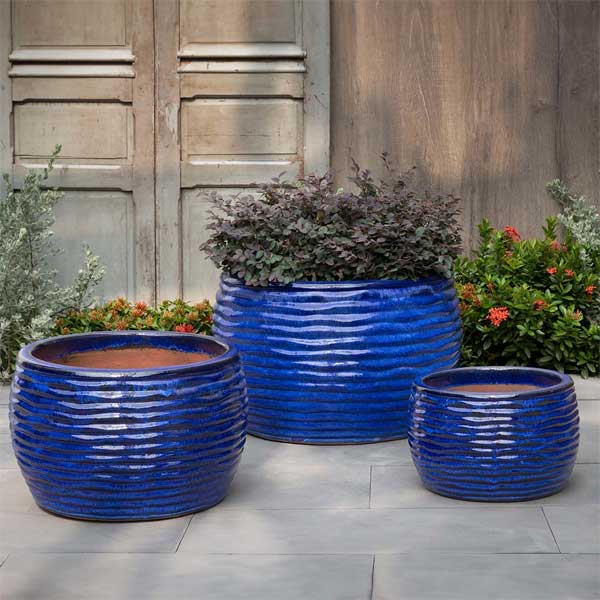 Montauk Planter - Riviera Blue - S/3 on concrete filled with plants