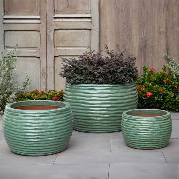 Montauk Planter - Sea Green - S/3 on concrete filled with plants