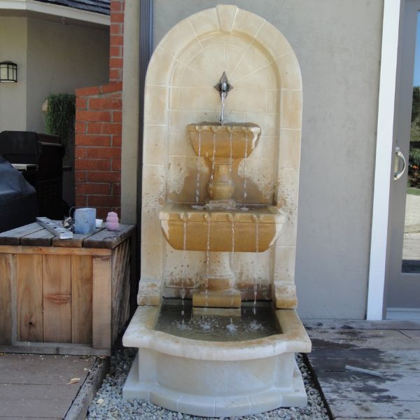 Monterosso Wall Fountain with Pond on concrete in action.