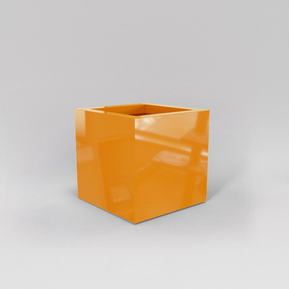 Montroy Cube Fiberglass Planter in gloss tangerine against gray background.