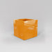 Montroy Cube Fiberglass Planter in gloss tangerine against gray background.