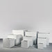 Montroy Cube Fiberglass Planter on concrete shown with different sizes.