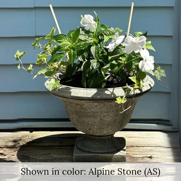 Moreland Urn Planter  with white flowers on wooden surface