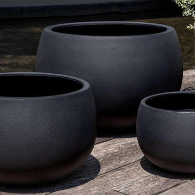 Norfolk Planter, Large in onyx black lite on concrete in the backyard.