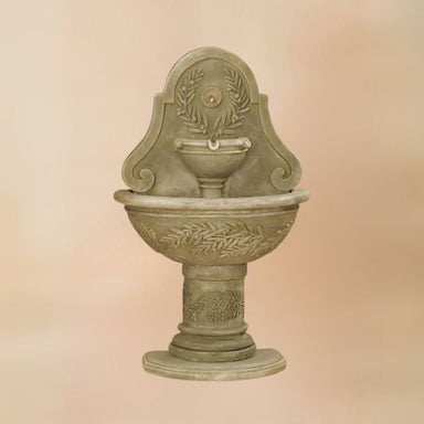 Oliva Wall Fountain against brown background.