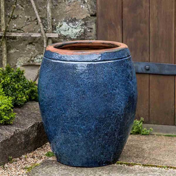 Olive Jar Planter on concrete in the backyard