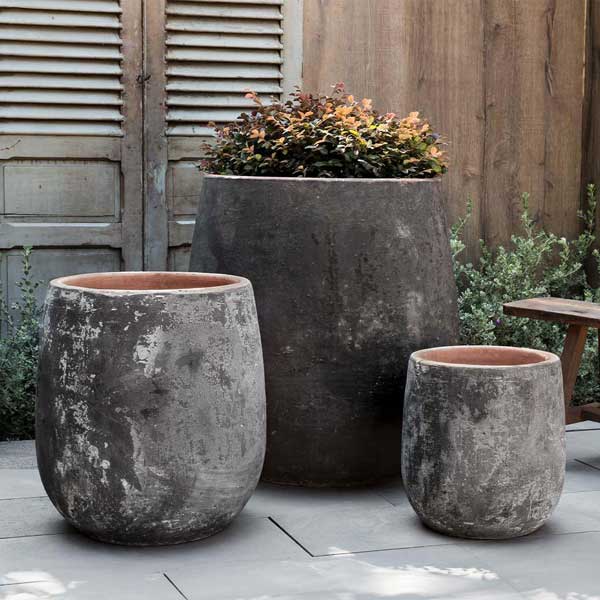 Otranto Planter - Vicolo Noir - S/3 filled with plants in the backyard