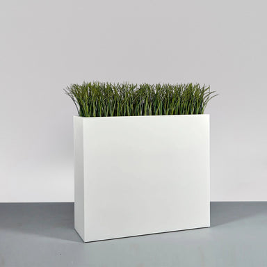 Perth Tall Rectangle Fiberglass Planter on concrete filled with plants.