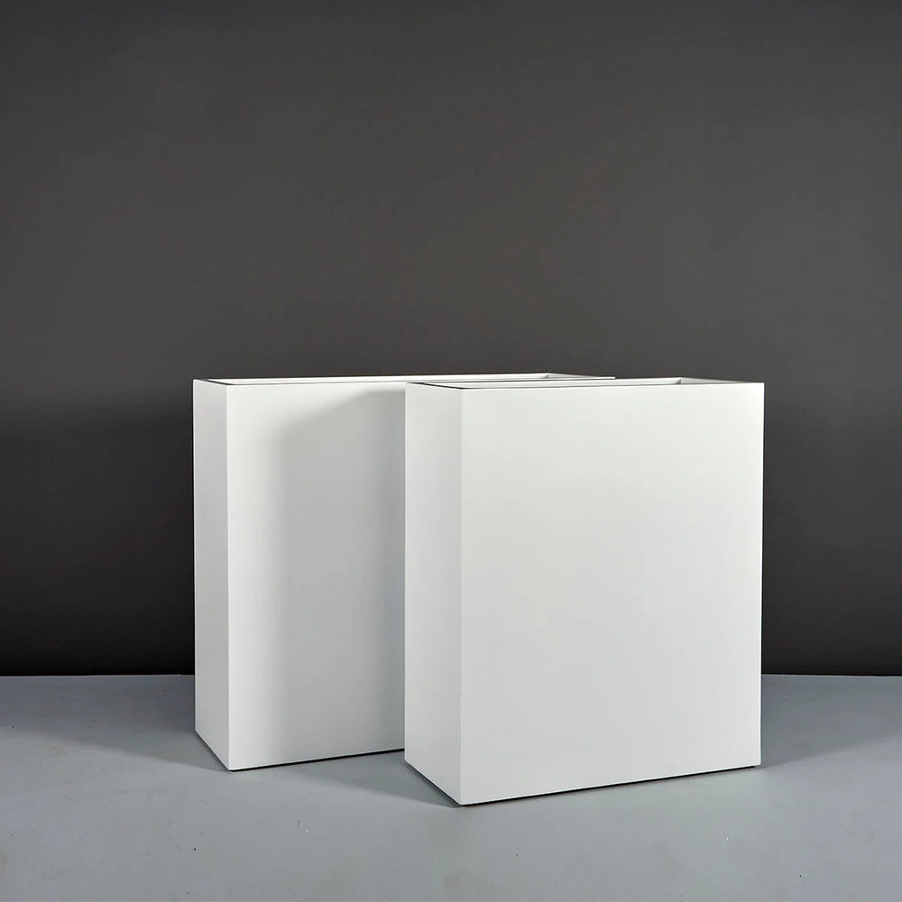 Perth Tall Rectangle Fiberglass Planter on concrete shown with different sizes.