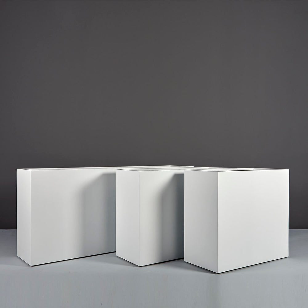 Potsdam Rectangle Fiberglass Planter on concrete shown with different sizes.