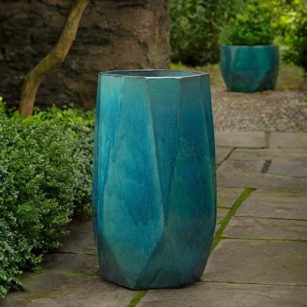 Prism Planter, Tall - Aqua on concrete in the backyard