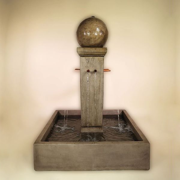 Quadrum Courtyard Fountain with Ball against brown background.