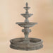 Quattro Lion Three Tier Pond Fountain against brown background.