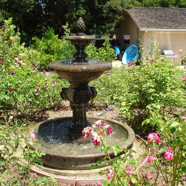 Quattro Lion Two Tier Pond Fountain in action in the backyard.