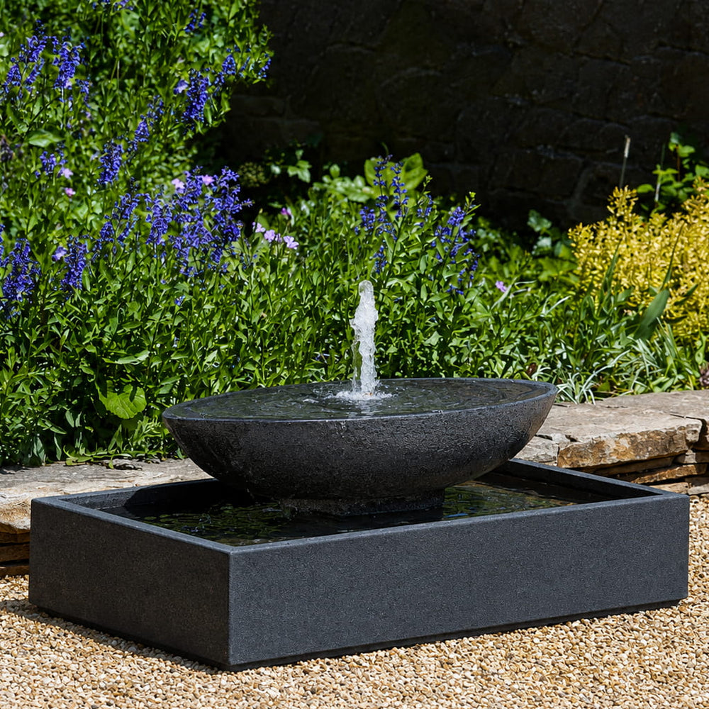 Recife Outdoor Bubbler Water Fountain in action on crushed gravel