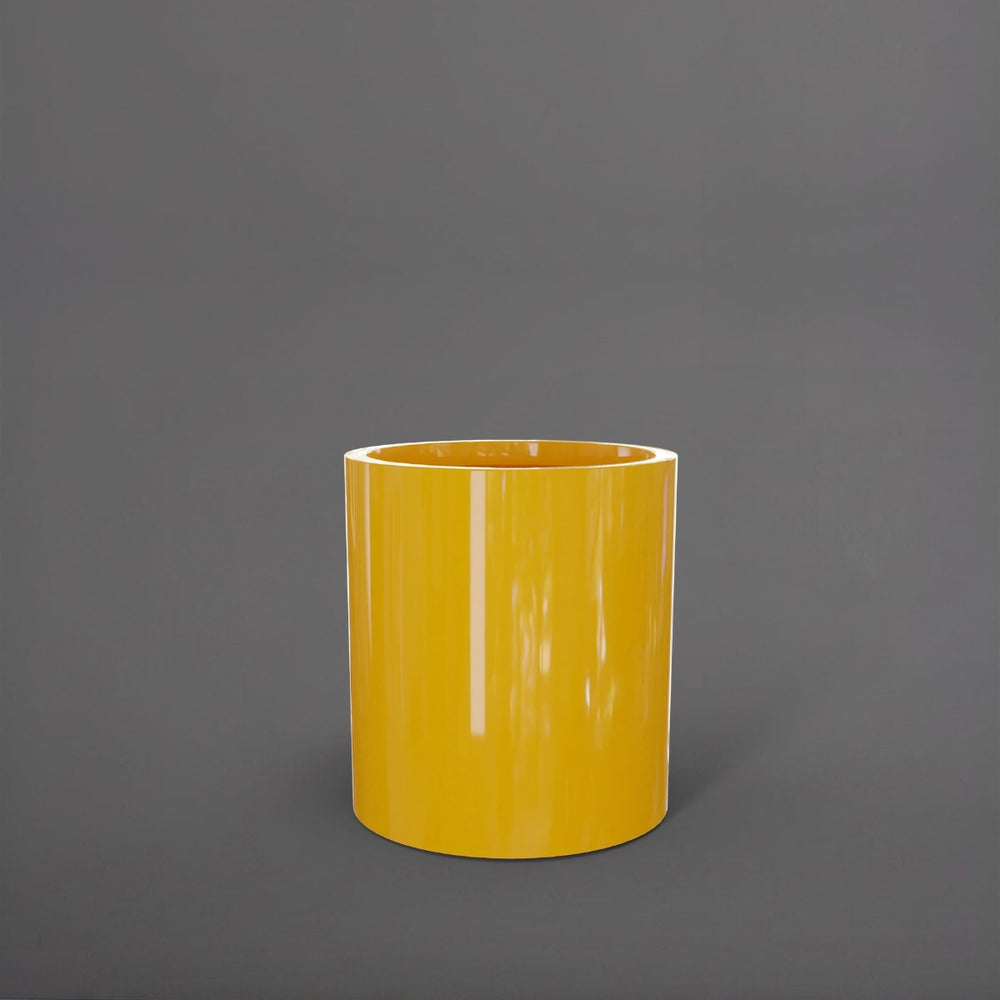 Rio Grande Cylinder Fiberglass Planter in gloss saffron against gray background.