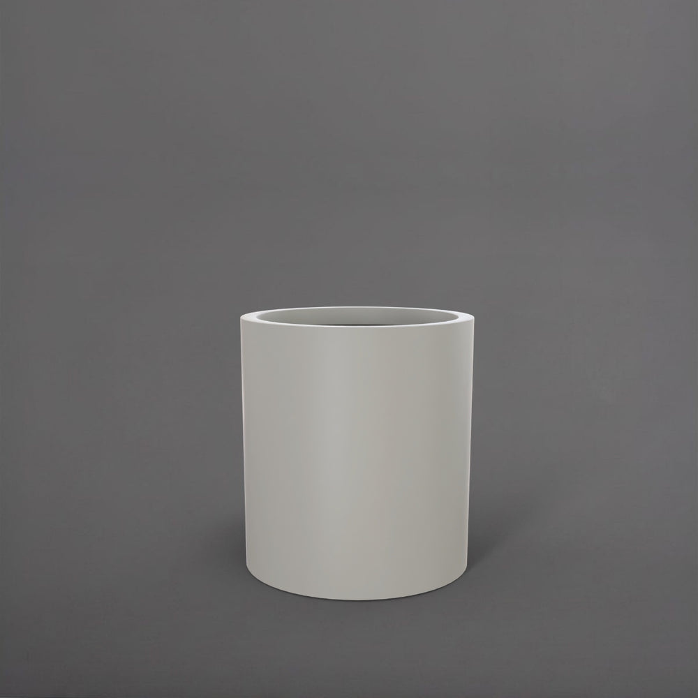 Rio Grande Cylinder Fiberglass Planter in matte cement grey against gray background.