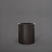 Rio Grande Cylinder Fiberglass Planter in matte charcoal against gray background.