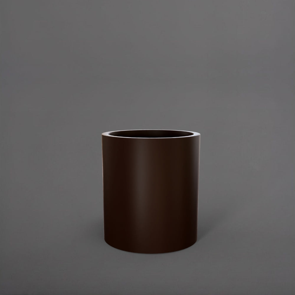 Rio Grande Cylinder Fiberglass Planter in matte dark brown against gray background.