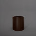 Rio Grande Cylinder Fiberglass Planter in matte dark brown against gray background.