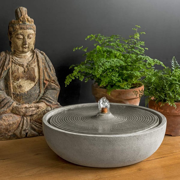 Ripple Fountain running beside buddha statue