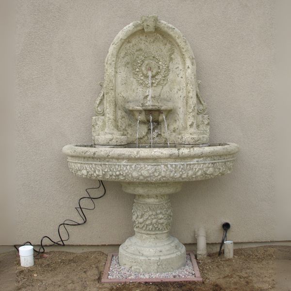 Robbiana Wall Fountain win action against cream wall.
