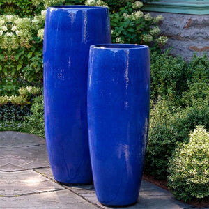 Sabine Planter, Tall - Riviera Blue - S/1 on concrete beside plants