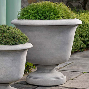 Sag Harbor Urn, Small and Large on concrete filled with plants upclose