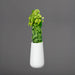 Saigon Tapered Round Fiberglass Planter filled with plants against white background.