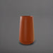 Saigon Tapered Round Fiberglass Planter in matte terra cotta against gray background.