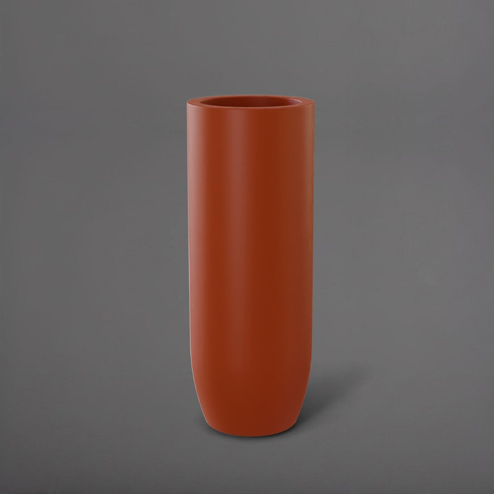 Saint Tropez Tall Bullet Round Fiberglass Planter in matte terra cotta against gray background.