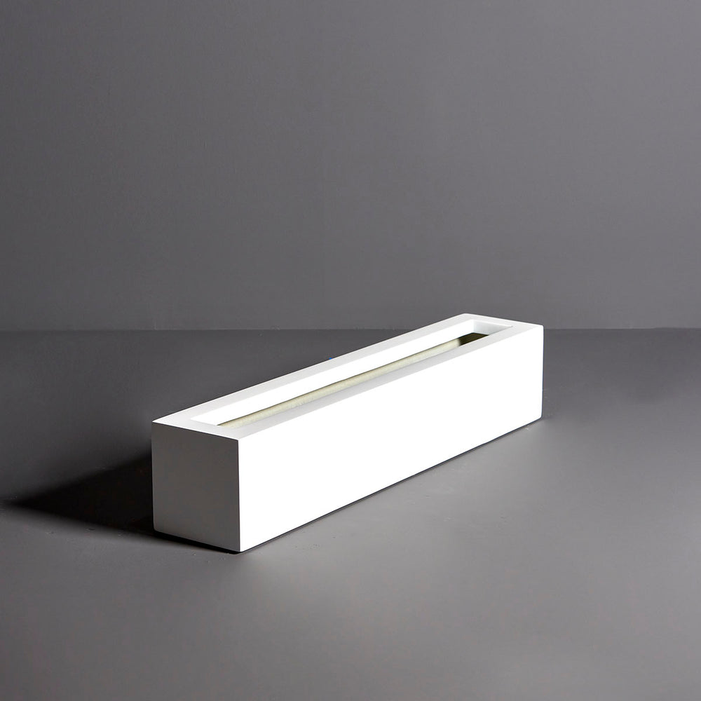 Salon Narrow Rectangle Fiberglass Planter on concrete against gray background in side view.