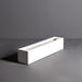 Salon Narrow Rectangle Fiberglass Planter on concrete against gray background in side view.
