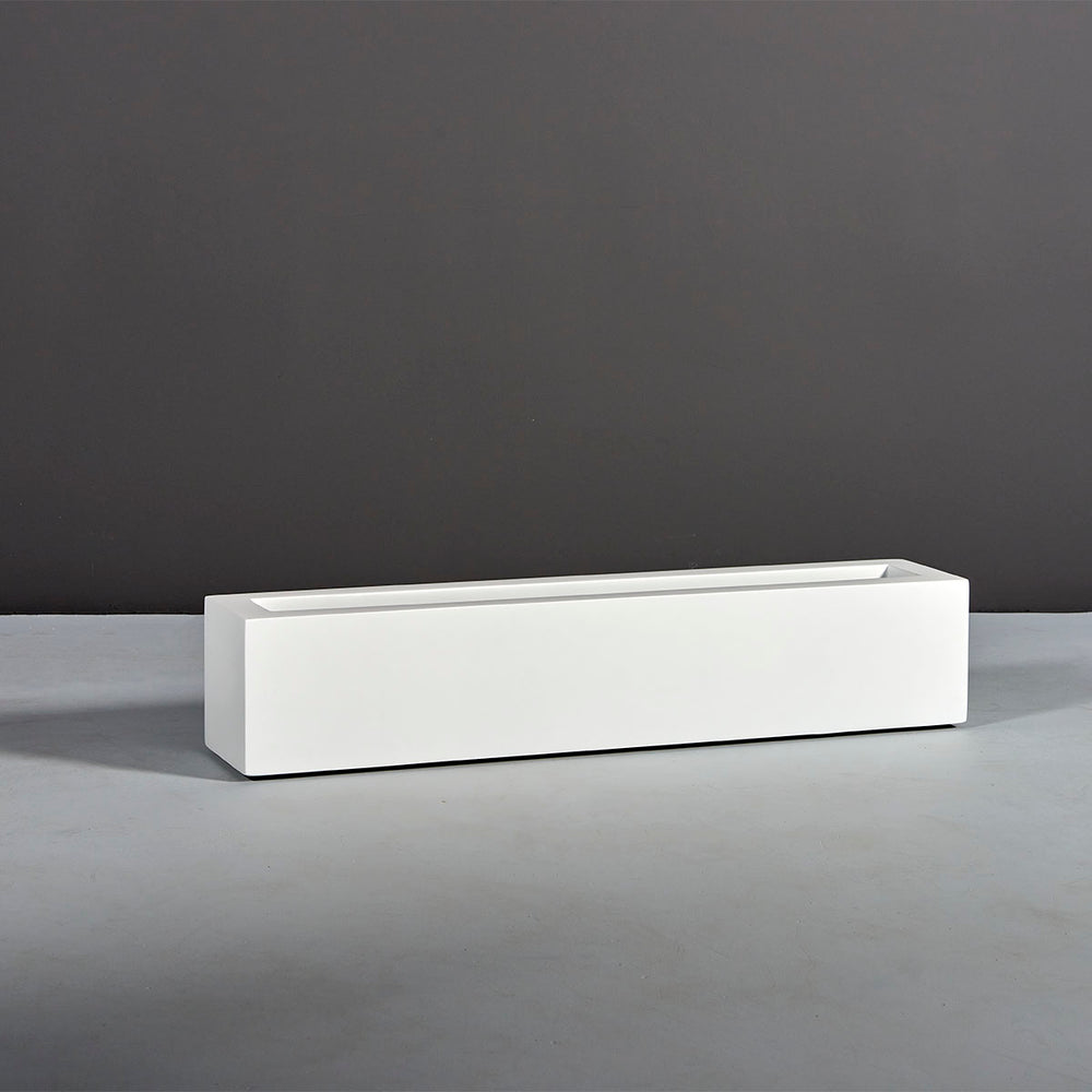 Salon Narrow Rectangle Fiberglass Planter on concrete against gray background.