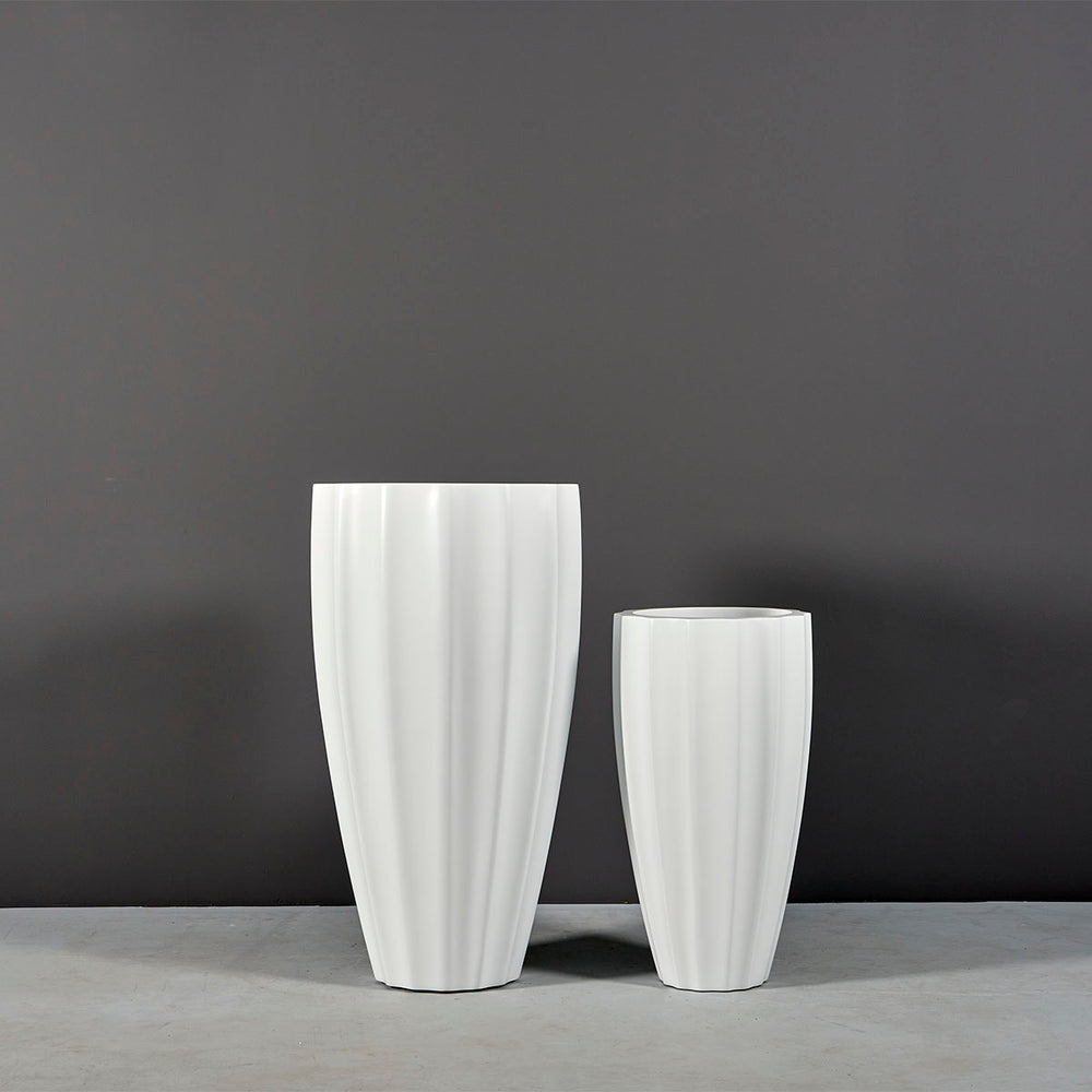 San Jose Tall Fluted Round Fiberglass Planter on concrete shown with different sizes.