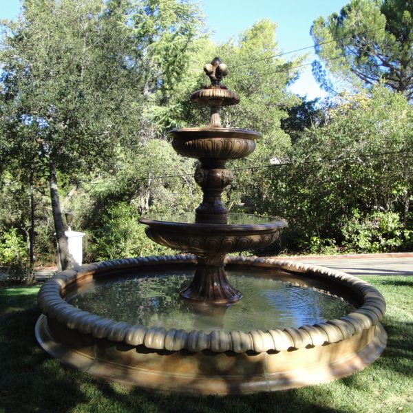 San Remo Fountain in action against green plants.