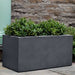 Sandal Planter 361818 S/1 in charcoal premium lite on concrete filled with plants.
